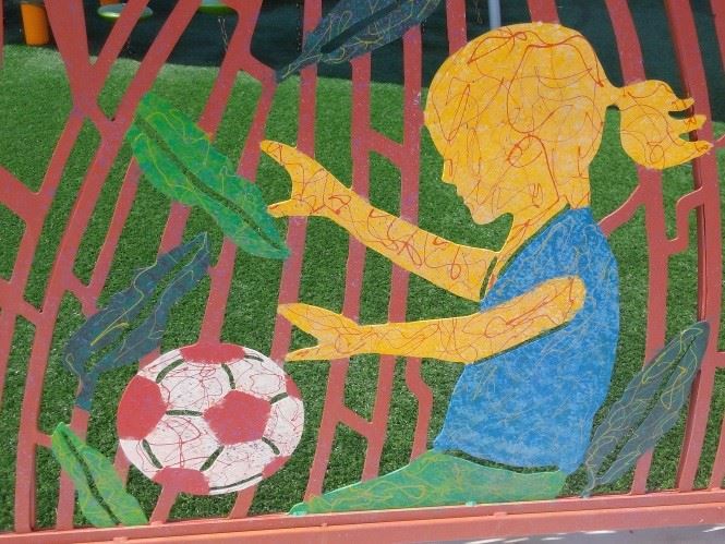 A mural painting of a girl playing soccer